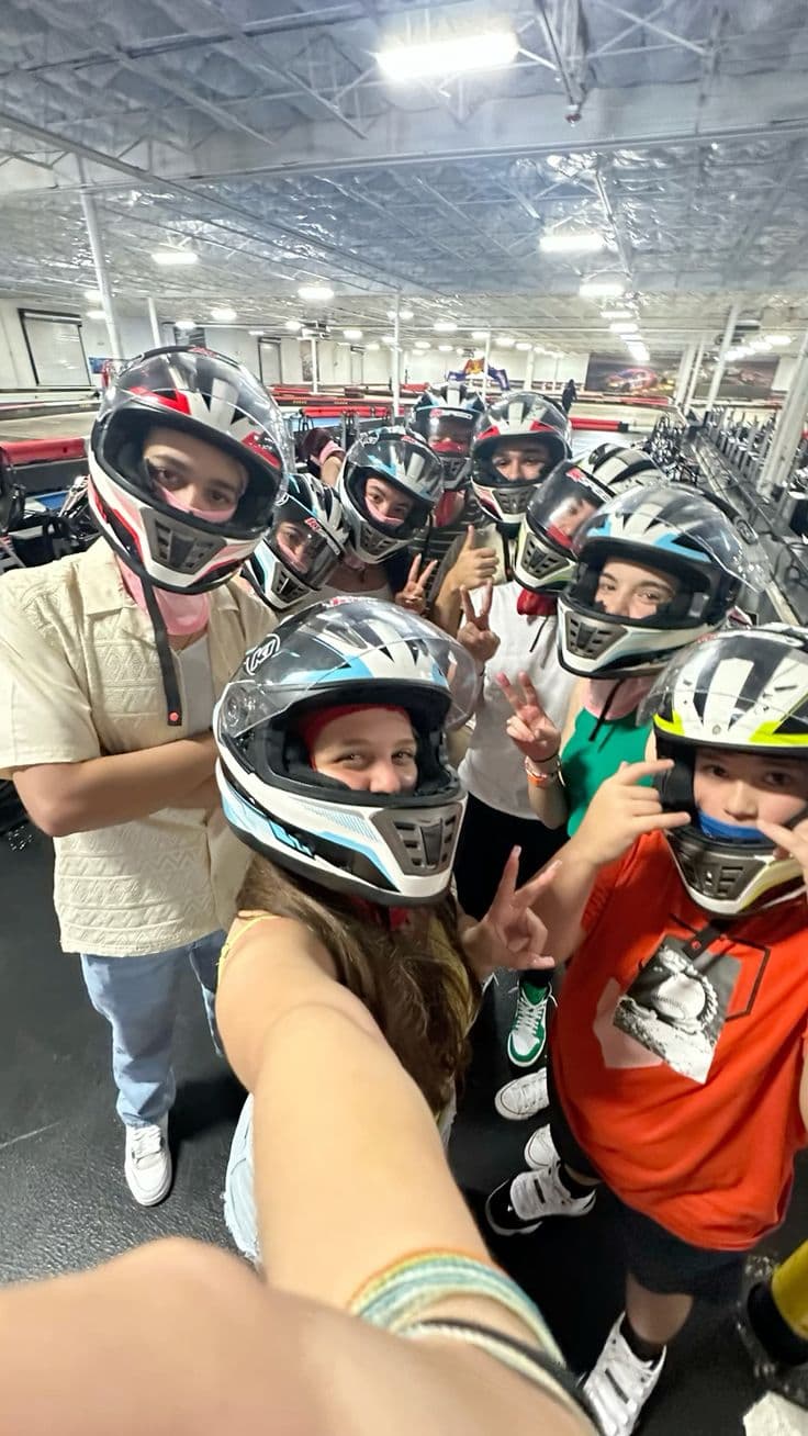 A group in racing helmets before a karting session